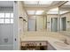 Clean bathroom with vanity, sink, and large mirror at 12912 Willoughby Ln, Hudson, FL 34667