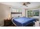 Bright bedroom with sliding glass doors leading to a patio at 12912 Willoughby Ln, Hudson, FL 34667