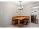 Breakfast nook boasts a wood table and bench, adjacent to dining room at 12912 Willoughby Ln, Hudson, FL 34667