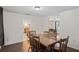 Dining area with wooden table and chairs, offering pool views at 12912 Willoughby Ln, Hudson, FL 34667