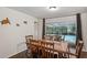 Dining room with wooden table and chairs, access to backyard at 12912 Willoughby Ln, Hudson, FL 34667
