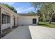 Home exterior showcasing a carport and landscaping at 12912 Willoughby Ln, Hudson, FL 34667