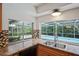 Kitchen with pool view, stainless steel sink, and wood cabinets at 12912 Willoughby Ln, Hudson, FL 34667