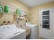 Laundry room with washer, dryer, and utility sink at 12912 Willoughby Ln, Hudson, FL 34667