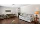 Spacious living room featuring comfortable sofas and hardwood floors at 12912 Willoughby Ln, Hudson, FL 34667