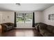 Bright living room with hardwood floors and large windows at 12912 Willoughby Ln, Hudson, FL 34667