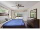 Main bedroom with sliding doors opening to the pool at 12912 Willoughby Ln, Hudson, FL 34667