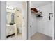 Bathroom with toilet and vanity; adjacent to a large closet at 660 Island Way # 401, Clearwater, FL 33767