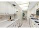 Bright kitchen with white cabinets and ample counter space at 660 Island Way # 401, Clearwater, FL 33767