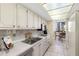 Bright kitchen with ample cabinetry and stainless steel appliances at 660 Island Way # 401, Clearwater, FL 33767