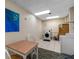 Convenient on-site laundry facility with a table and chairs at 660 Island Way # 401, Clearwater, FL 33767