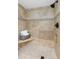 Spa-like shower with beige tile and built-in seat at 660 Island Way # 401, Clearwater, FL 33767