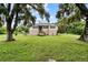 House exterior featuring a tan home with black shutters and a well-maintained lawn at 7205 86Th E St, Palmetto, FL 34221