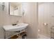Bathroom featuring a stylish sink with chrome stand and adjacent toilet in a separated space at 7000 Beach Plz # 505, St Pete Beach, FL 33706
