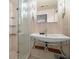 Bathroom featuring a stand alone sink, chrome fixtures and a glass enclosed shower with storage shelving at 7000 Beach Plz # 505, St Pete Beach, FL 33706
