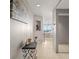 Inviting hallway showcasing tiled flooring, tasteful decor, and a glimpse of the beach view beyond at 7000 Beach Plz # 505, St Pete Beach, FL 33706