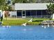 Pelicans flying over calm waters with a house in the background at 6087 16Th Ne Ln, St Petersburg, FL 33703