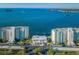 Aerial view of waterfront property with two towers and a boat at 300 Woodette Dr # 202B, Dunedin, FL 34698