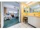 Clean bathroom with vanity, and view into bedroom at 300 Woodette Dr # 202B, Dunedin, FL 34698