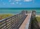 Wooden boardwalk leads to the beach at 300 Woodette Dr # 202B, Dunedin, FL 34698