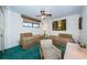 Guest bedroom with two twin beds and seating at 300 Woodette Dr # 202B, Dunedin, FL 34698
