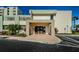 Modern building entrance with paved pathway at 300 Woodette Dr # 202B, Dunedin, FL 34698