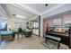 Relaxing common area with wicker furniture, fireplace, and piano at 300 Woodette Dr # 202B, Dunedin, FL 34698
