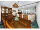 Bright dining area with wood table and chairs, offering a view to the living room at 300 Woodette Dr # 202B, Dunedin, FL 34698