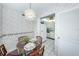 Dining area with glass table and kitchen view at 300 Woodette Dr # 202B, Dunedin, FL 34698