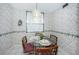 Small dining area with glass table and floral wallpaper at 300 Woodette Dr # 202B, Dunedin, FL 34698