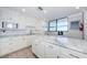 Spacious kitchen with white cabinets and marble countertops at 300 Woodette Dr # 202B, Dunedin, FL 34698