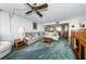 Living room with sectional sofa and wood coffee table, offering a view to the dining area at 300 Woodette Dr # 202B, Dunedin, FL 34698