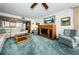 Relaxing living room featuring comfortable seating and a view into the dining area at 300 Woodette Dr # 202B, Dunedin, FL 34698
