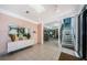 Bright lobby with tiled floors, seating area, and staircase at 300 Woodette Dr # 202B, Dunedin, FL 34698
