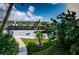 Condo complex with covered parking and lush landscaping at 300 Woodette Dr # 202B, Dunedin, FL 34698