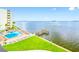 Community pool and deck overlooking the water at 300 Woodette Dr # 202B, Dunedin, FL 34698