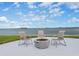 Relaxing waterfront patio with fire pit and seating at 300 Woodette Dr # 202B, Dunedin, FL 34698