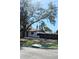 House exterior view with large tree and fenced backyard at 1800 Montana Ne Ave, St Petersburg, FL 33703