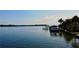 Scenic view of a waterfront home with a private dock and a boat, offering serene living at 2121 Bayou Grande Ne Blvd, St Petersburg, FL 33703