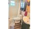 Bright bathroom featuring tiled shower, cabinet, and neutral decor at 1172 Chelsea Ln, Holiday, FL 34691
