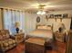 Comfortable bedroom featuring a ceiling fan, furnishings, and ample natural light at 1172 Chelsea Ln, Holiday, FL 34691