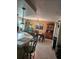 Bright dining room boasts a table with chairs, brick accent wall and custom painted furniture for added charm at 1172 Chelsea Ln, Holiday, FL 34691