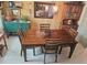 Dining room showcases brick wall, hutch, and a dining table with four chairs at 1172 Chelsea Ln, Holiday, FL 34691