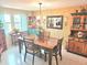 Bright dining room boasts a table with four chairs, brick accent wall and stylish decorative cabinet at 1172 Chelsea Ln, Holiday, FL 34691