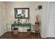 Hallway featuring a decorative table with mirror and lamps and stylish decor at 1172 Chelsea Ln, Holiday, FL 34691