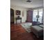 Comfortable living room with an accent rug, armchair, and decorative cabinet, creating a cozy space for relaxation and gatherings at 1172 Chelsea Ln, Holiday, FL 34691