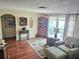 Cozy living room features a large accent rug, armchair, and decorative cabinet perfect for relaxing and entertaining guests at 1172 Chelsea Ln, Holiday, FL 34691