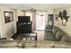 Inviting living room with comfortable seating, TV, and sliding glass doors to the outdoor space at 1172 Chelsea Ln, Holiday, FL 34691