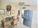 Home office featuring a desk, refrigerator, and shelving, illuminated by a ceiling fan and natural light at 1172 Chelsea Ln, Holiday, FL 34691
