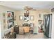 Home office featuring a desk, shelves, and decor, illuminated by a ceiling fan and natural light at 1172 Chelsea Ln, Holiday, FL 34691